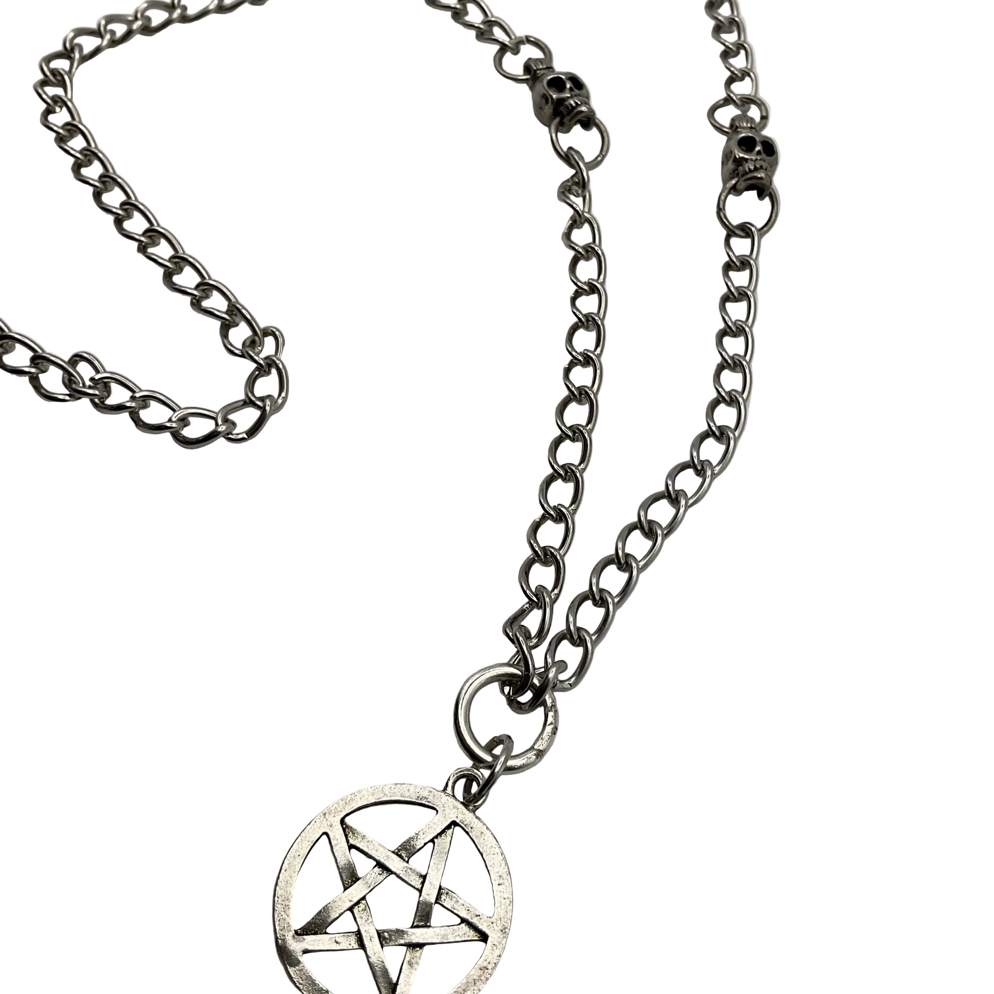 Silver tone chain necklace with a pentacle pendant with skull beads on a white background
