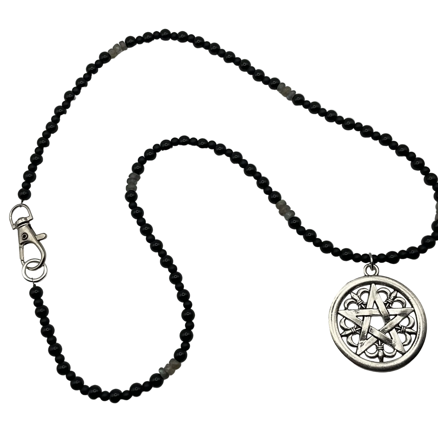 Black beaded necklace with a silver pentacle with fleur de lis design pendant on a light white background