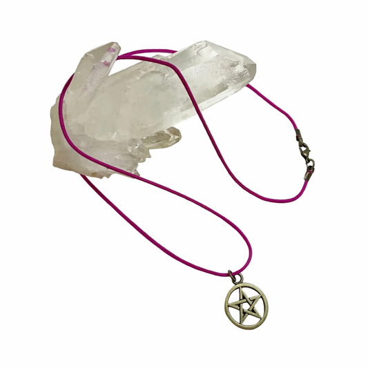 Necklace with bronze tone pentacle pendant on a pink cord, displayed against a white background.