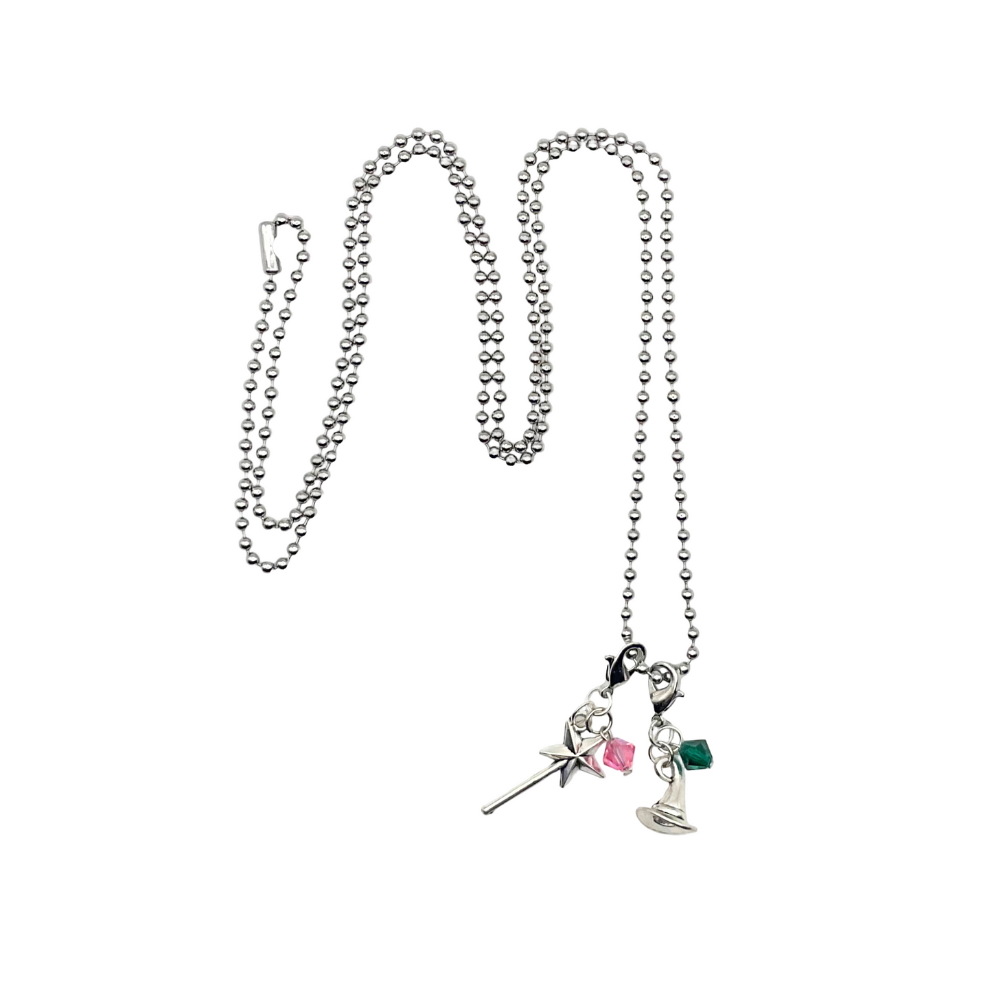 Necklace with pink and green witch charms on a white background