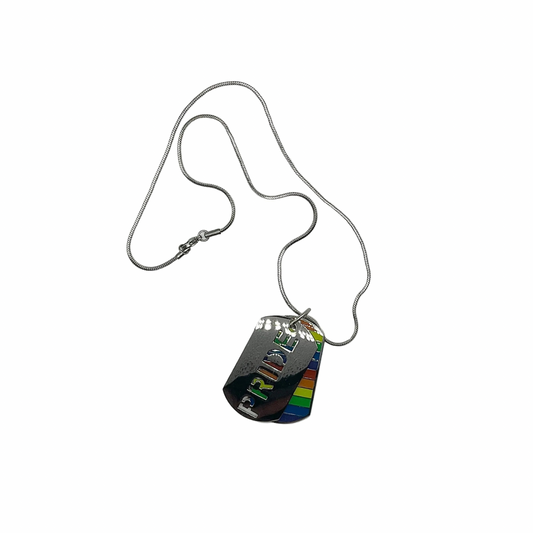 Metallic dog tag with rainbow design under a tag with the word “PRIDE” cut out…displayed on a white background