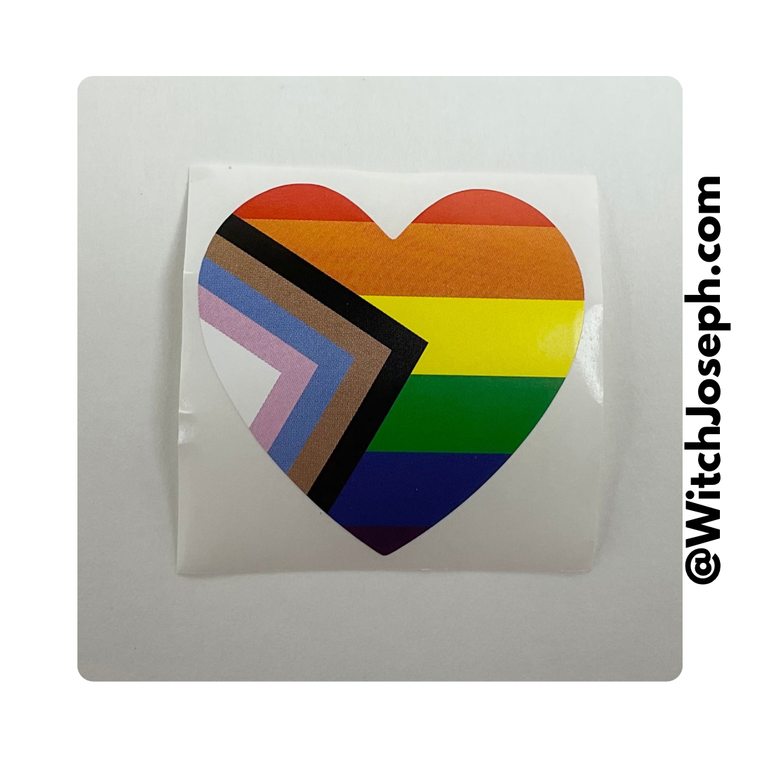Heart-shaped sticker with rainbow progress pride design on a white background