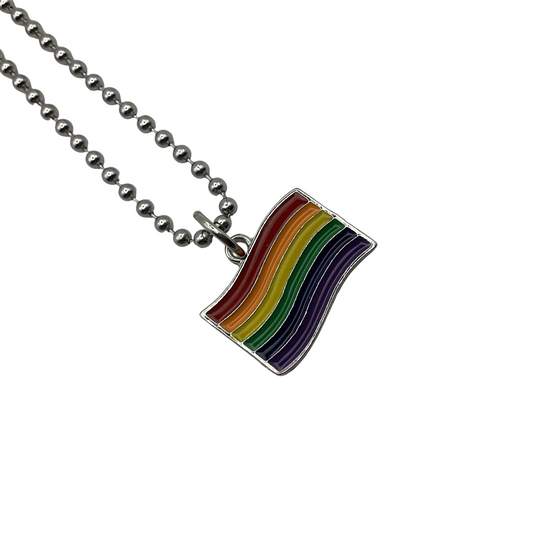 Rainbow flag charm pendant on a ball chain charm necklace against a white background