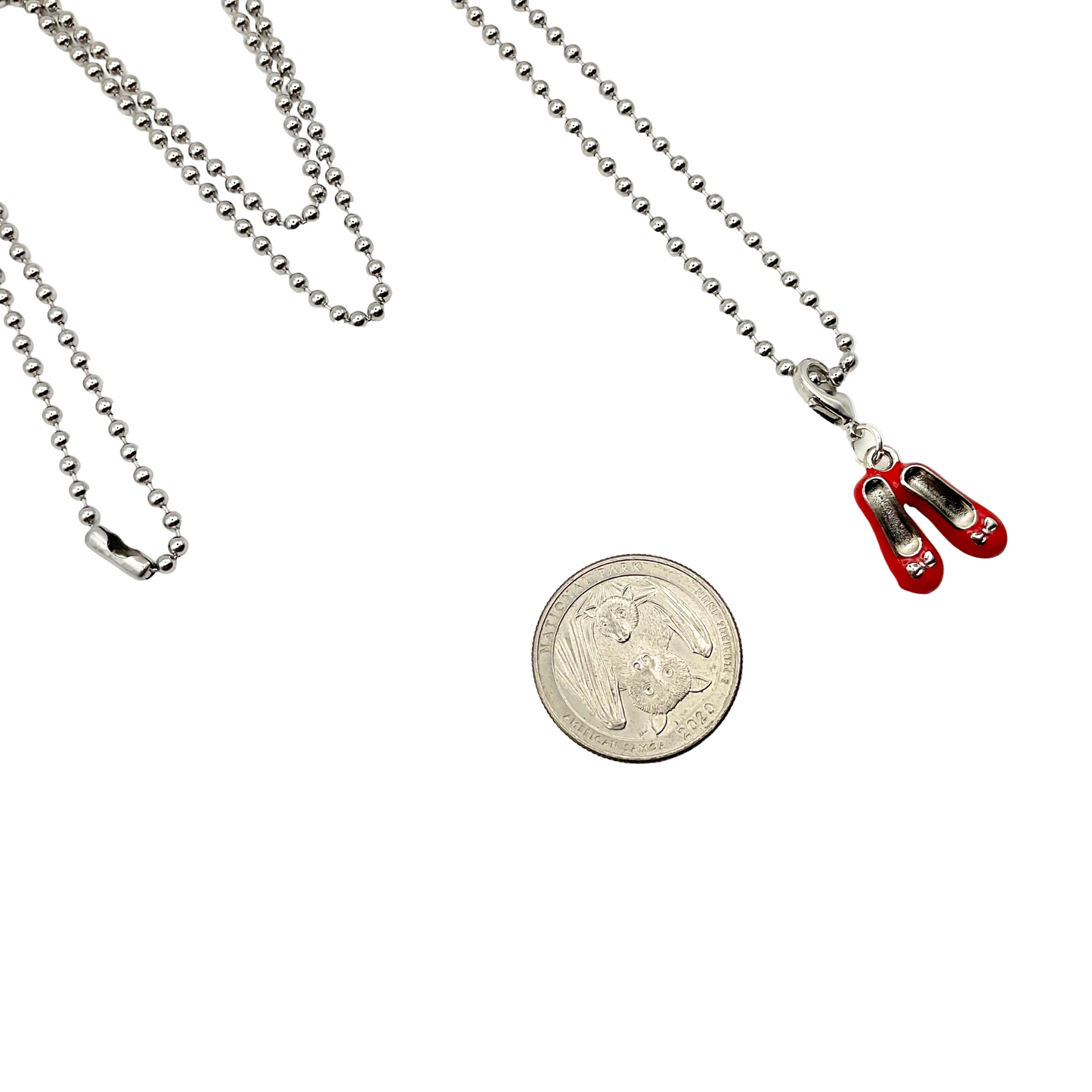 Red shoes Necklace with a coin on a white background