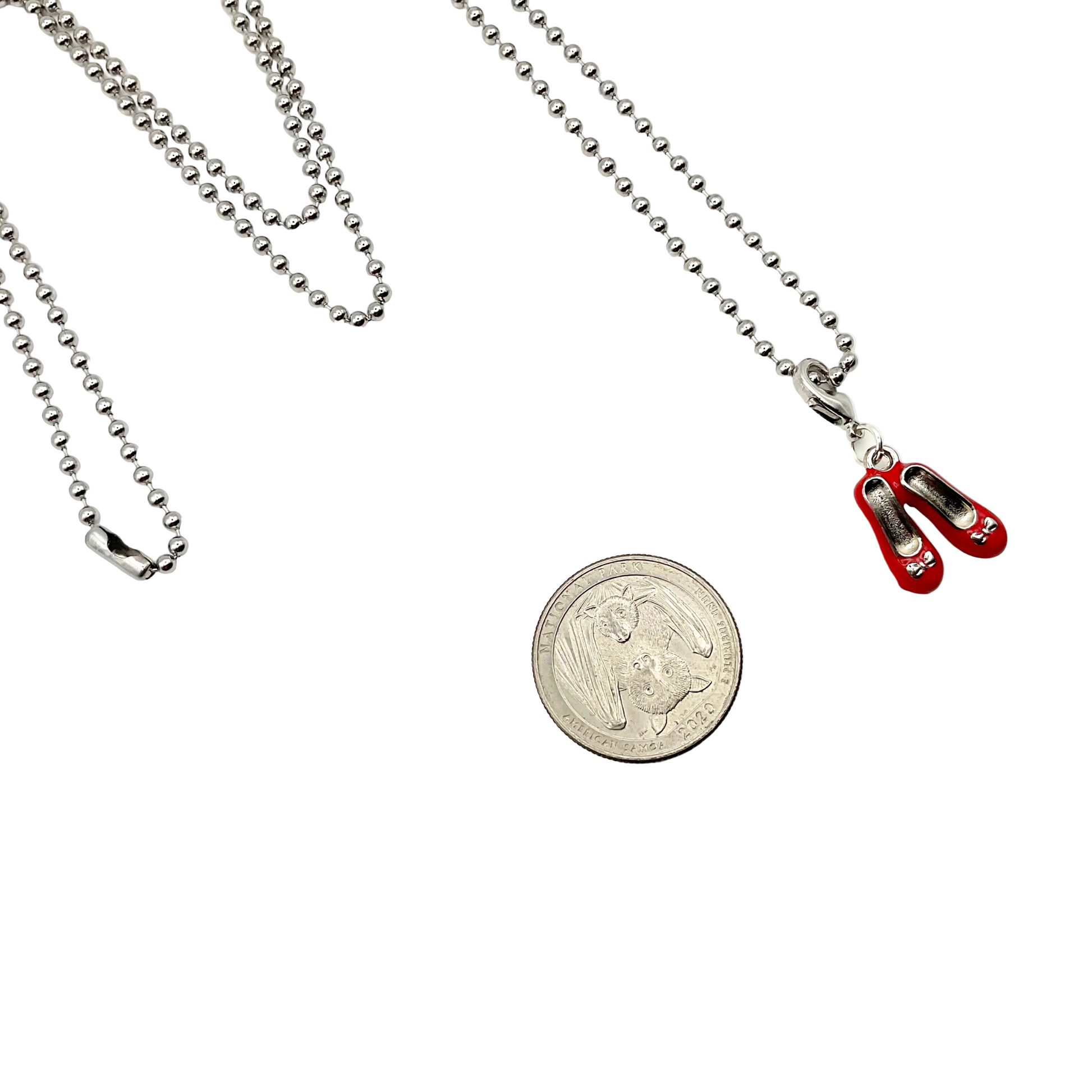 Red shoes Necklace with a coin on a white background
