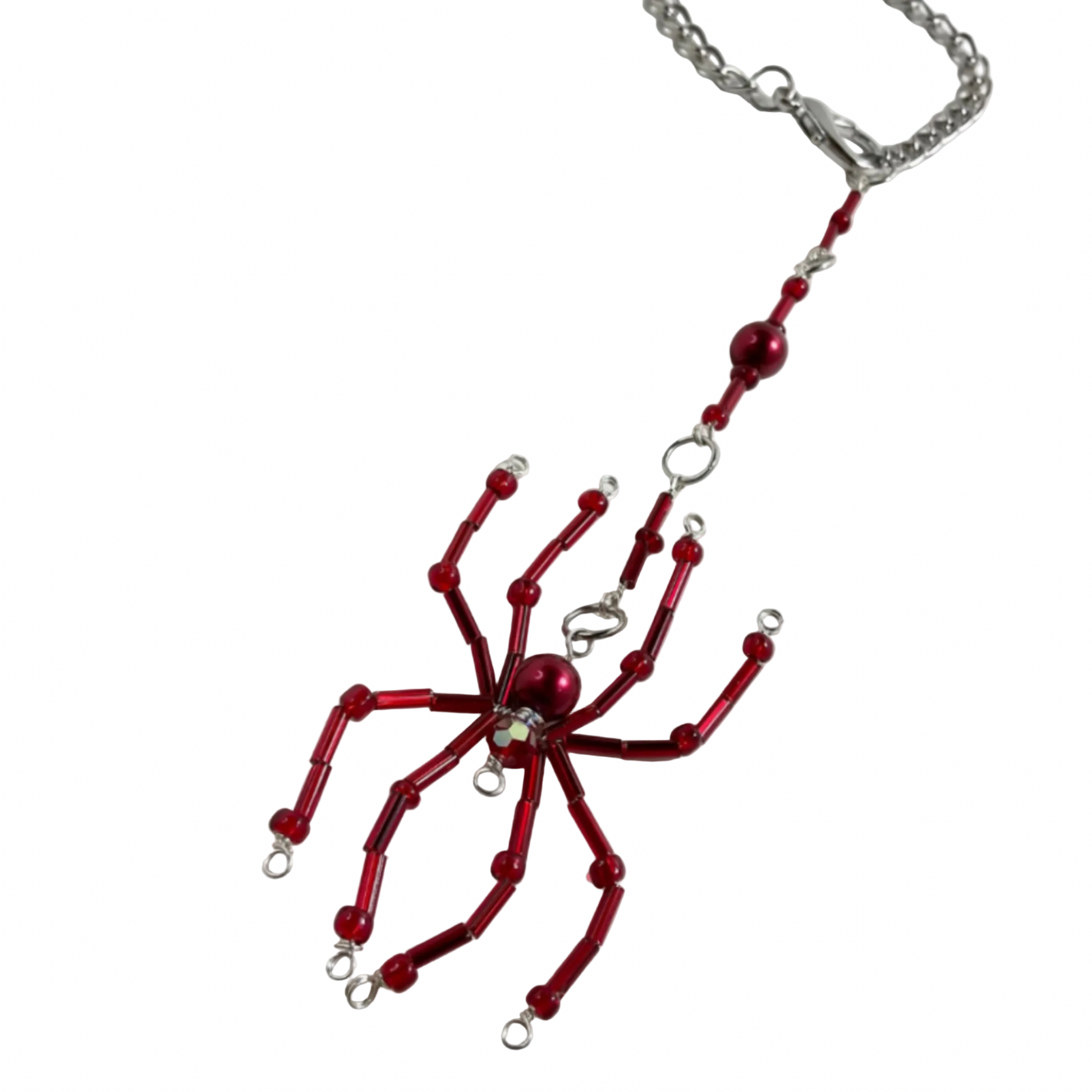 Red spider-shaped sun catcher car charm on a chain against a white background