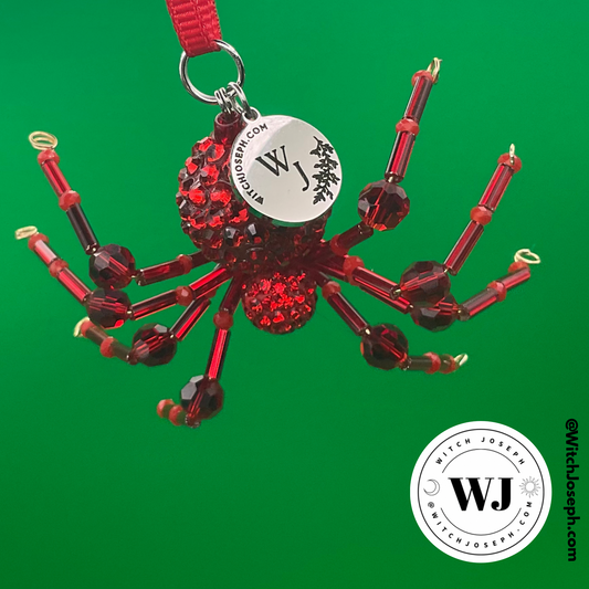Red spider ornament on a green background with the Witch Joseph logo