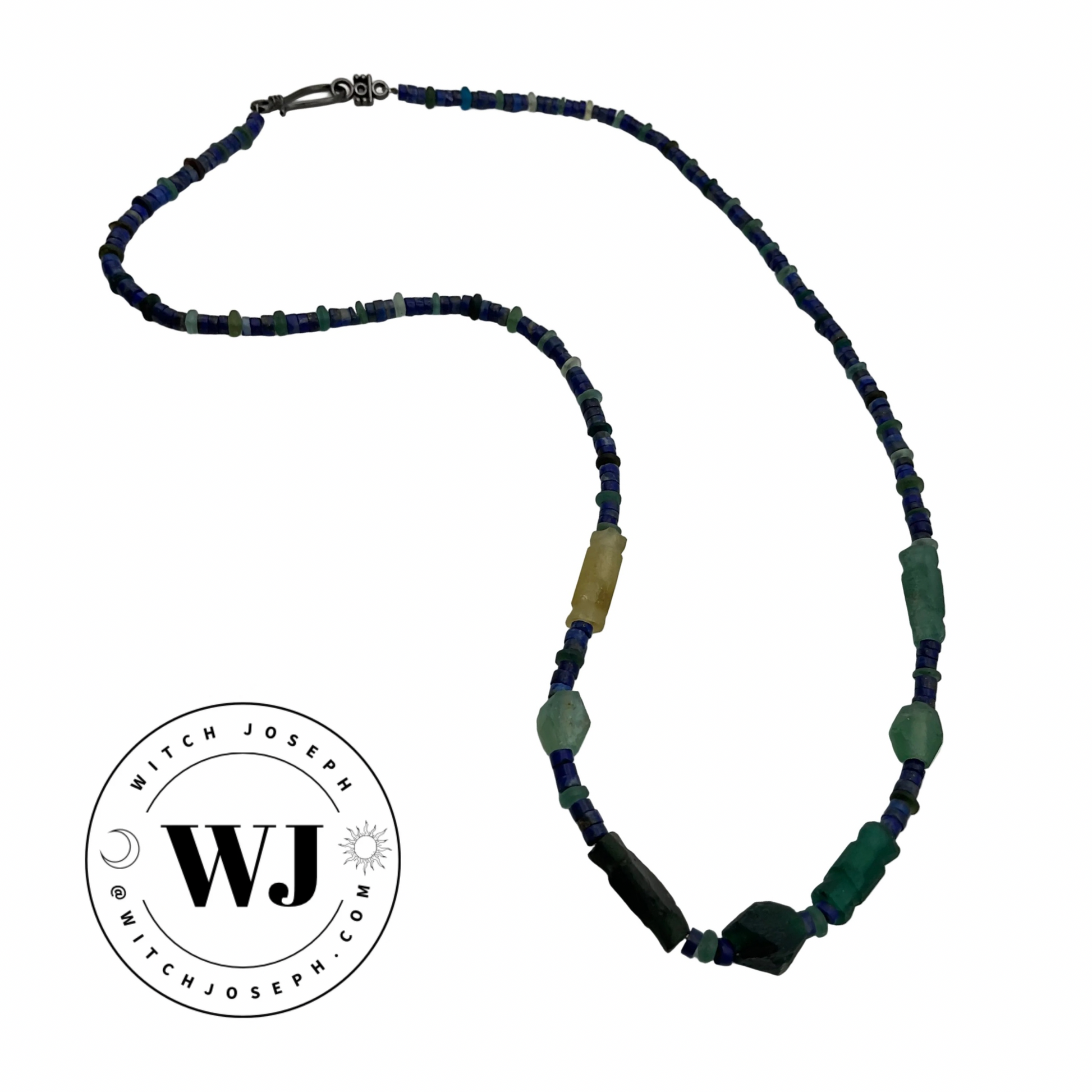 Beaded necklace with blue, green, and yellow beads, Roman glass and lapis lazuli on a white background, featuring the Witch Joseph logo