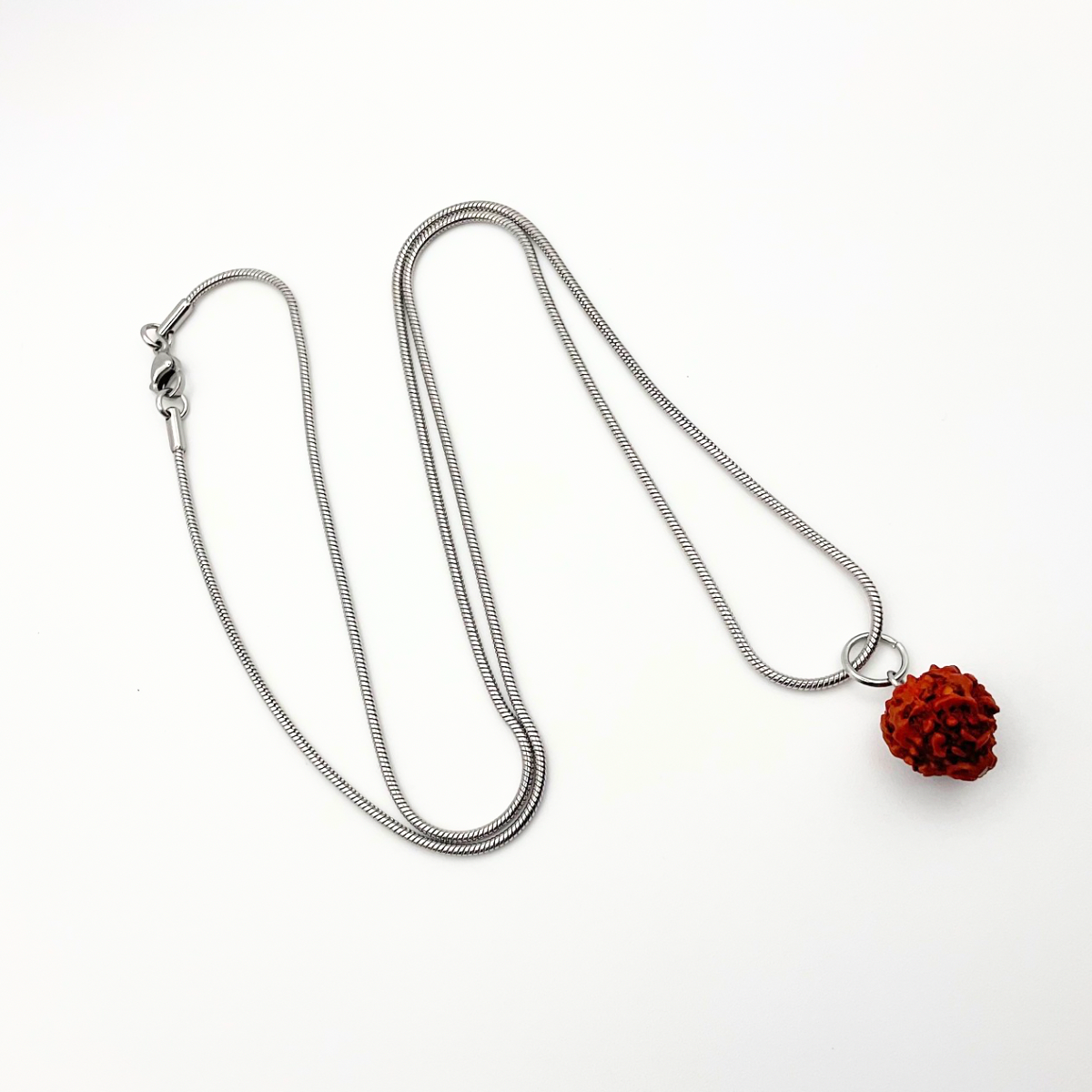 A photo of the Rudraksha bead necklace on a 24 inch stainless steel snake chain for sale.