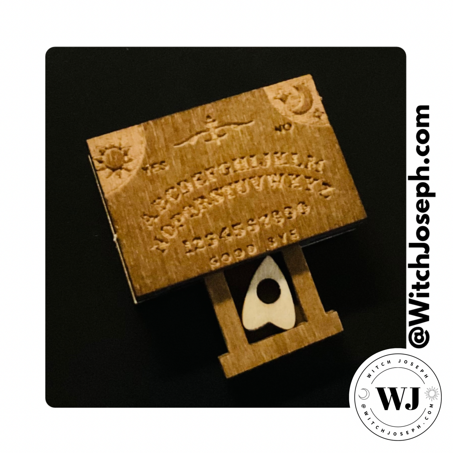 Mini Wooden ouija with alphabet and numbers and a planchette in a tiny drawer displayed on a black background, branded 'Witch Joseph'.