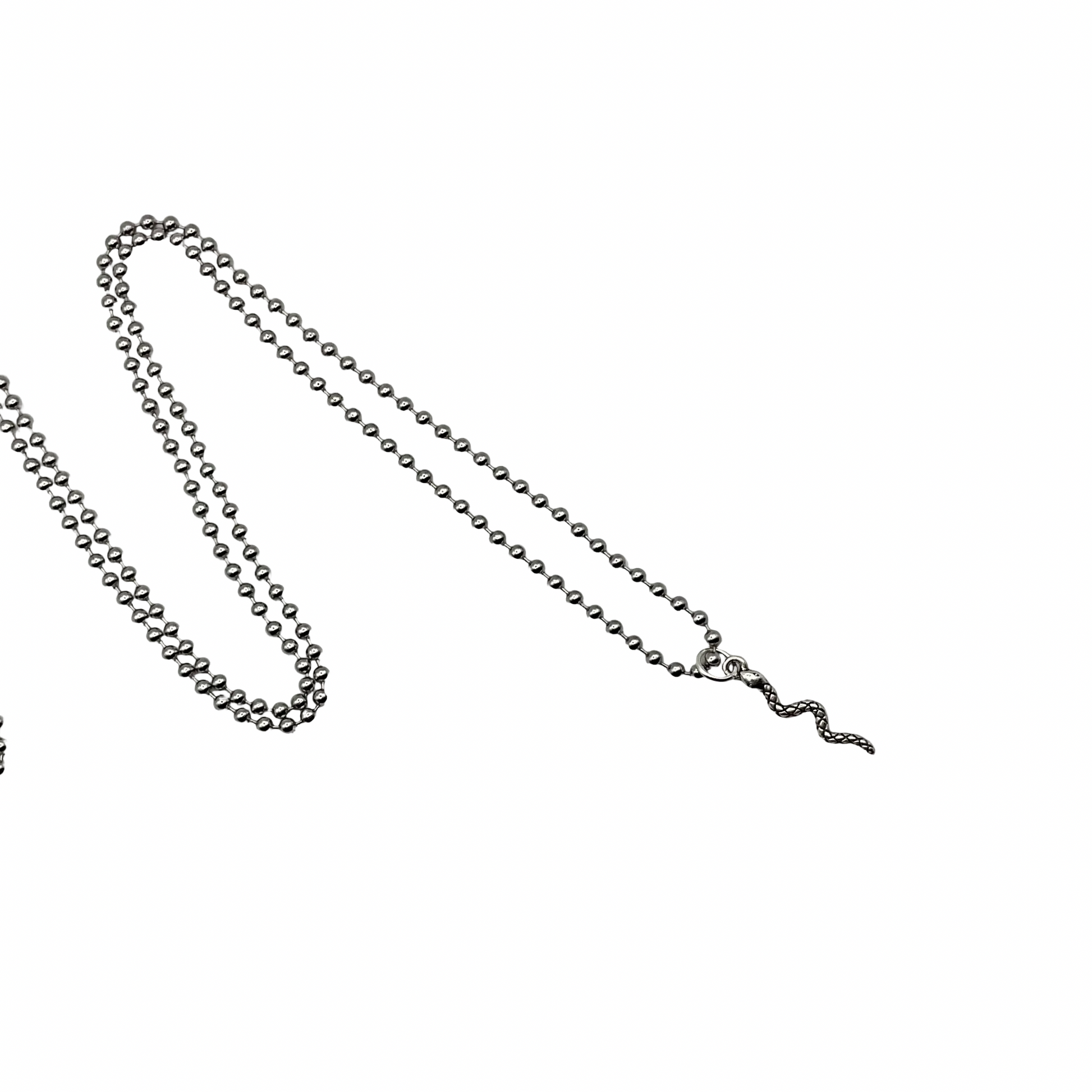 Silver tone ball chain necklace with delicate  silver tone snake charm on a white background