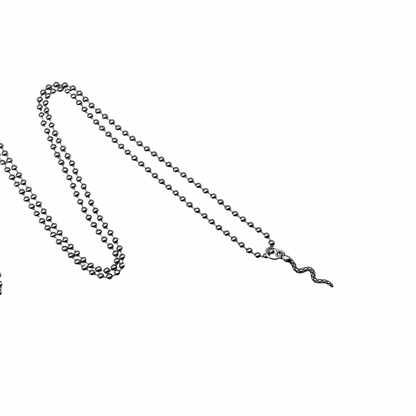 Silver tone ball chain necklace with delicate  silver tone snake charm on a white background
