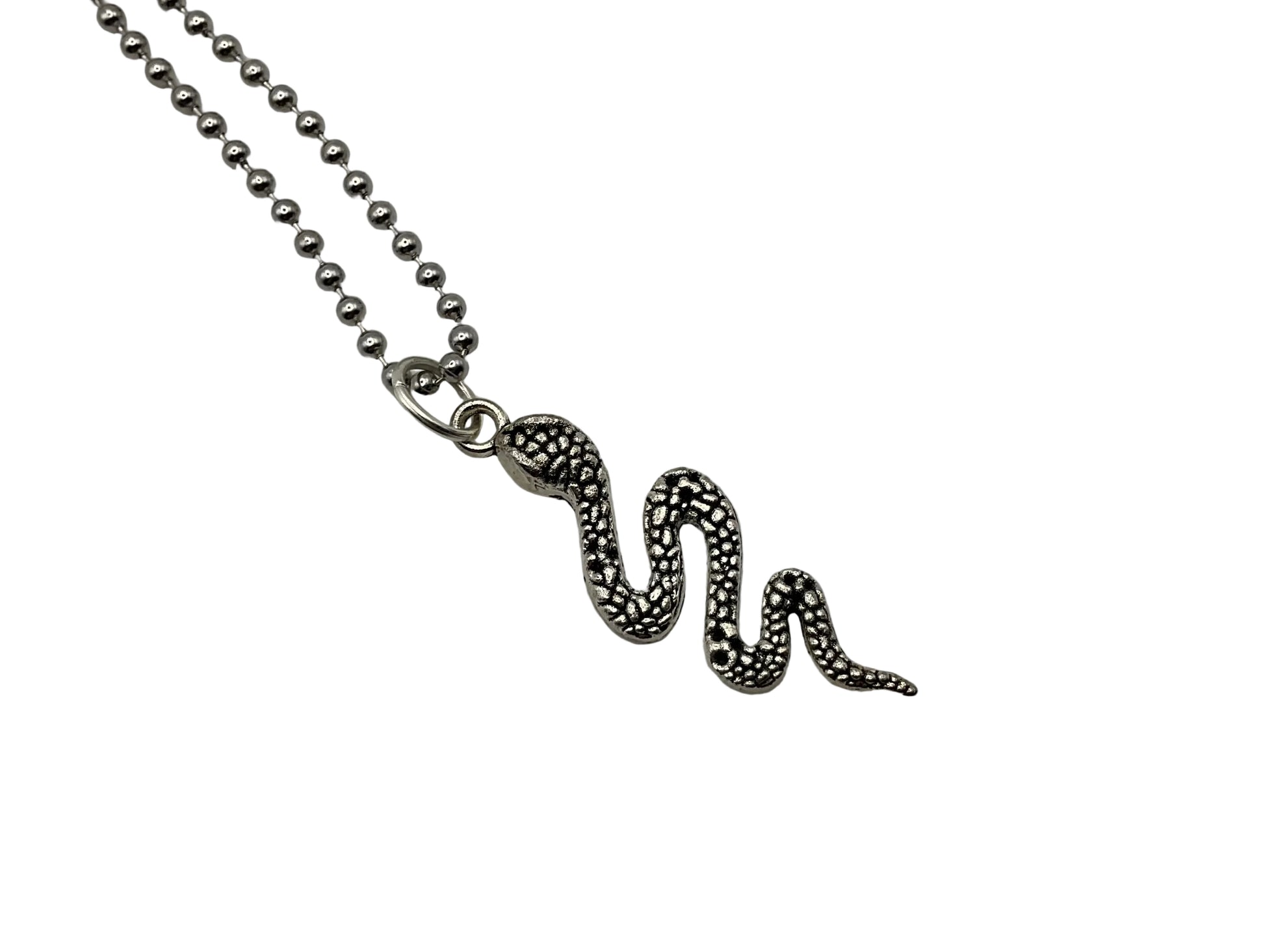 Snake-shaped pendant on a ball chain against a white background