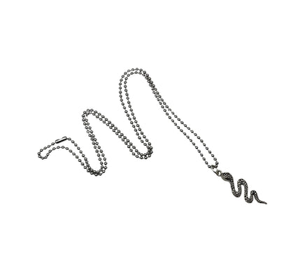 Snake-shaped charm pendant on a ball chain against a white background