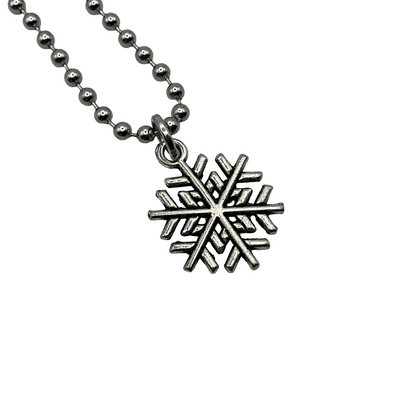 Silver snowflake charm pendant on a ball chain against a white background
