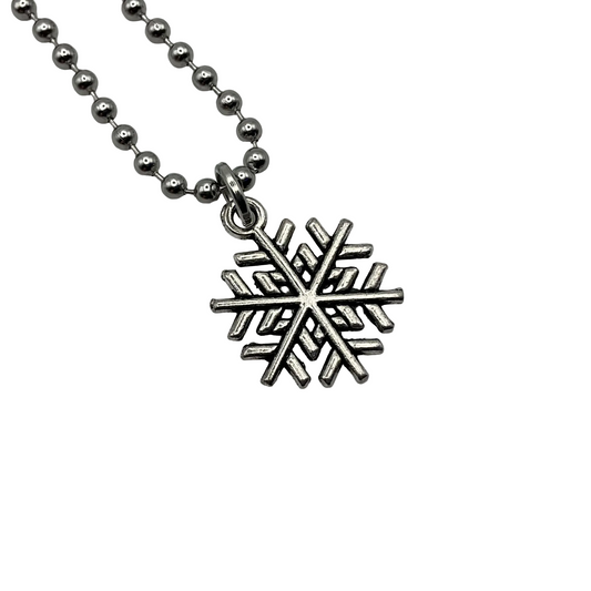 Silver snowflake charm pendant on a ball chain against a white background