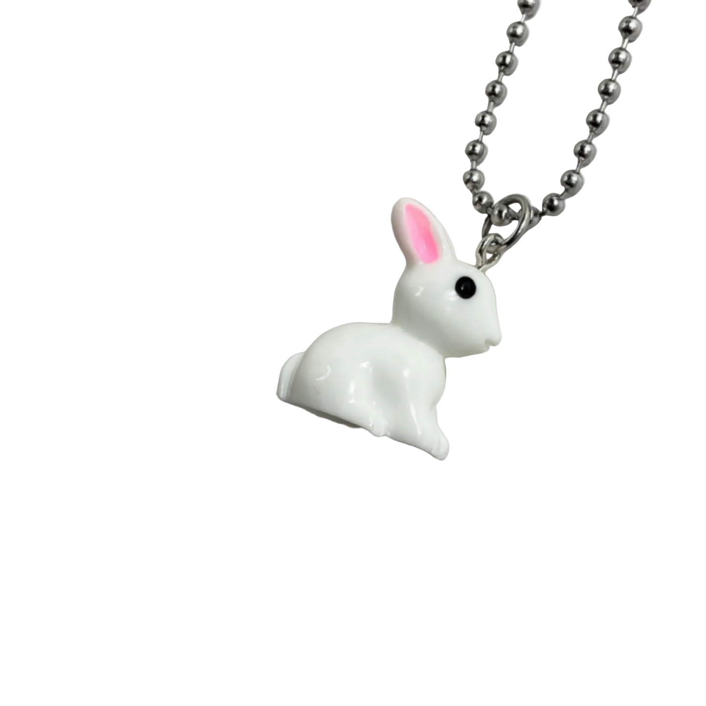 White rabbit-shaped pendant on a chain against a white background.