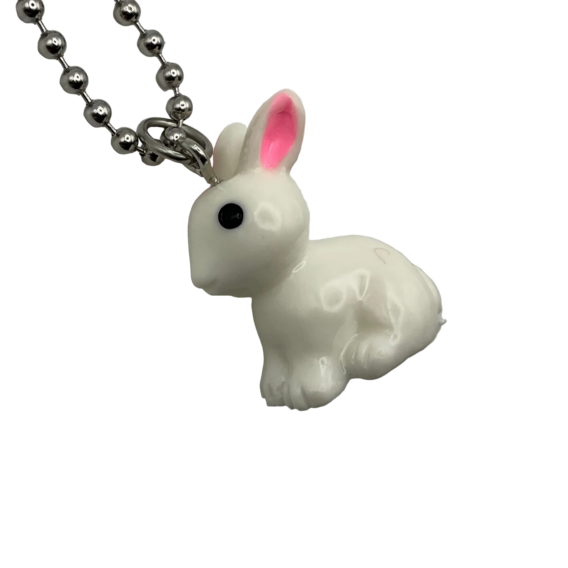 White rabbit-shaped pendant with pink inner ear on a ball chain displayed on a white  background