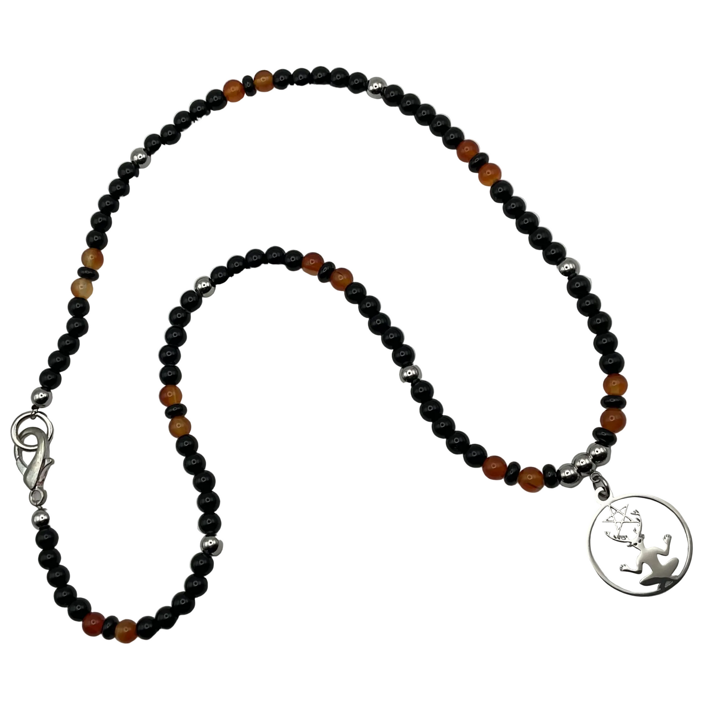Necklace with black and orange beads and a silver tone cernunnos pendant on a white background