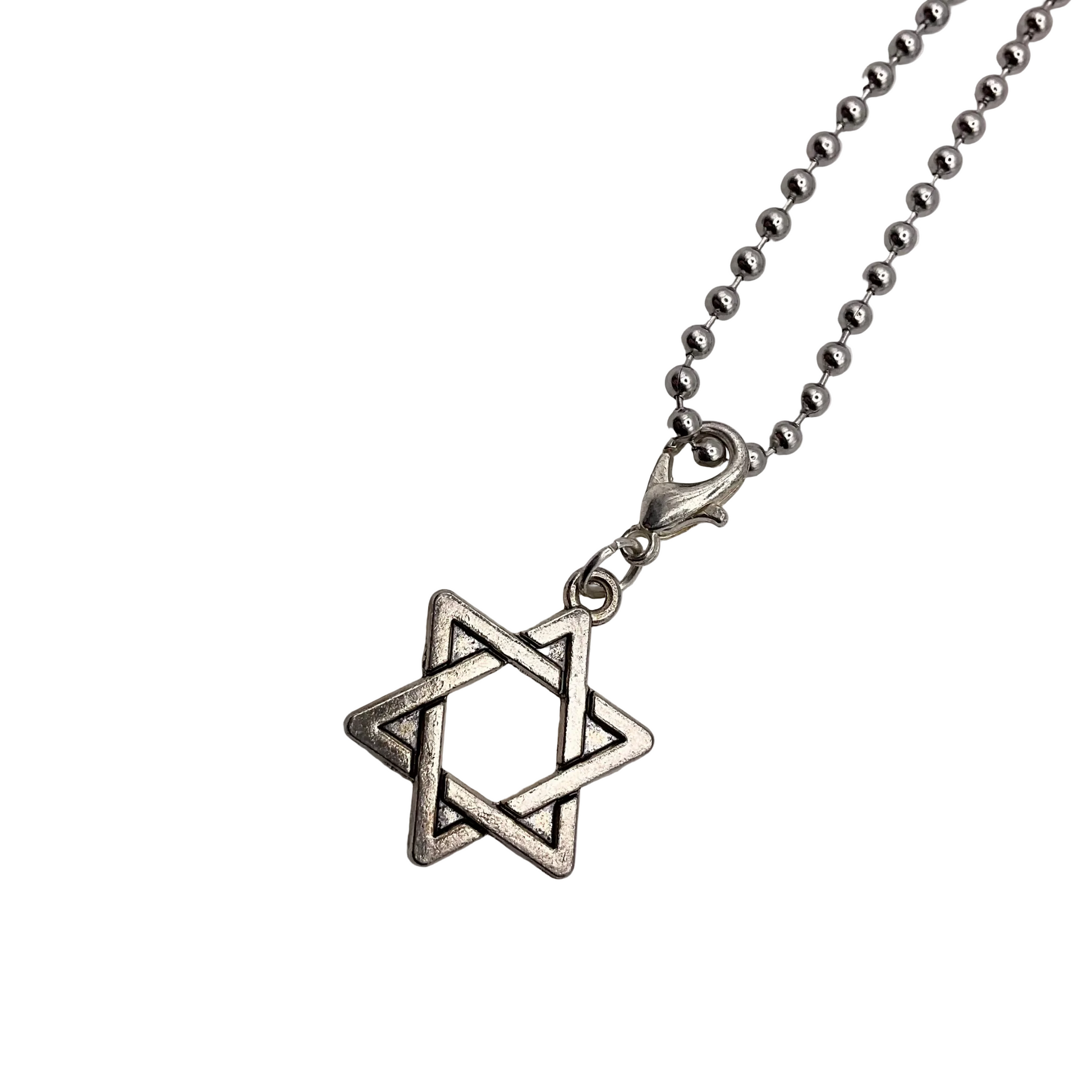 Silver tone Star of David charm necklace on a white background.