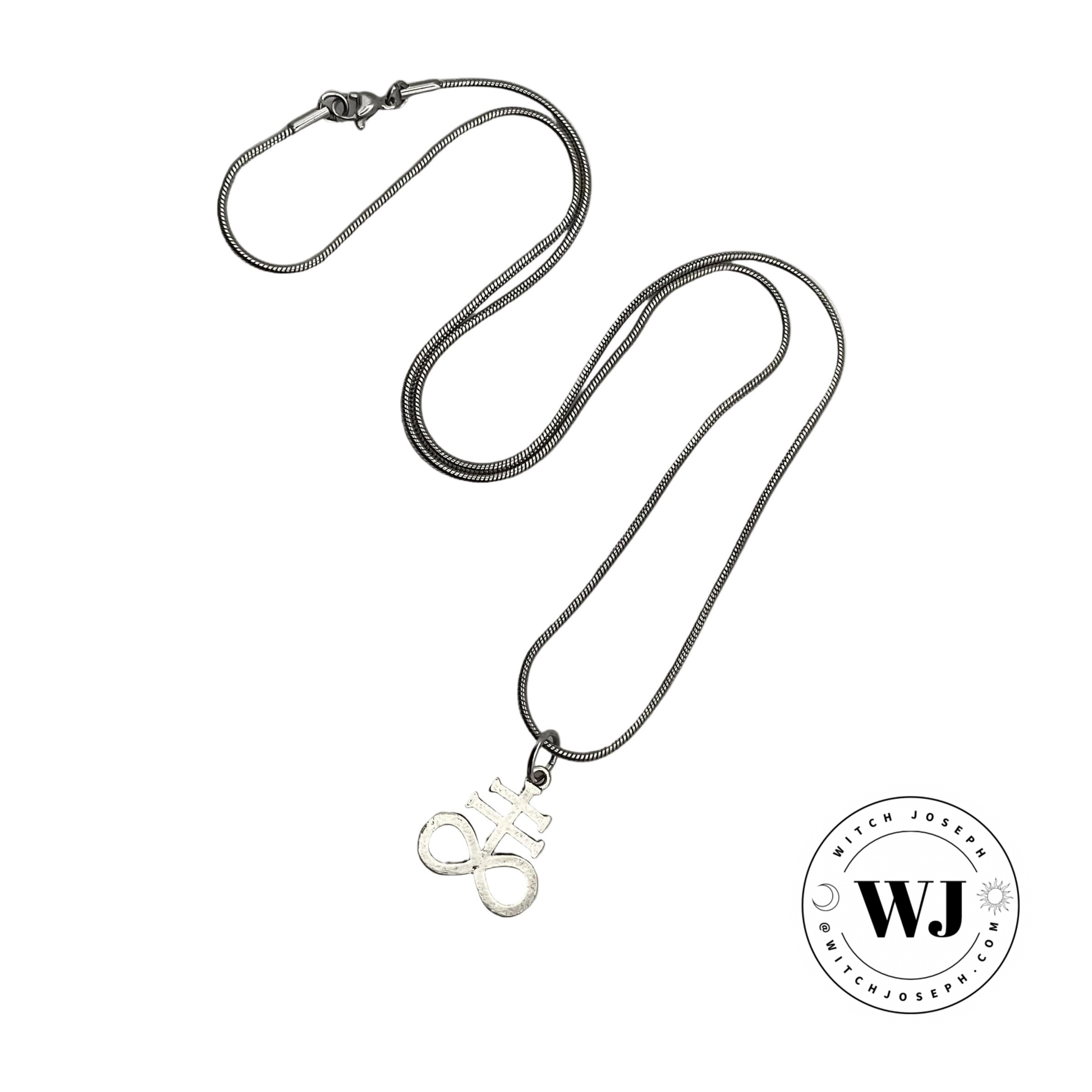 Silver tone necklace with an alchemical sulphur symbol pendant on a white background, featuring the brand 'WJ'.