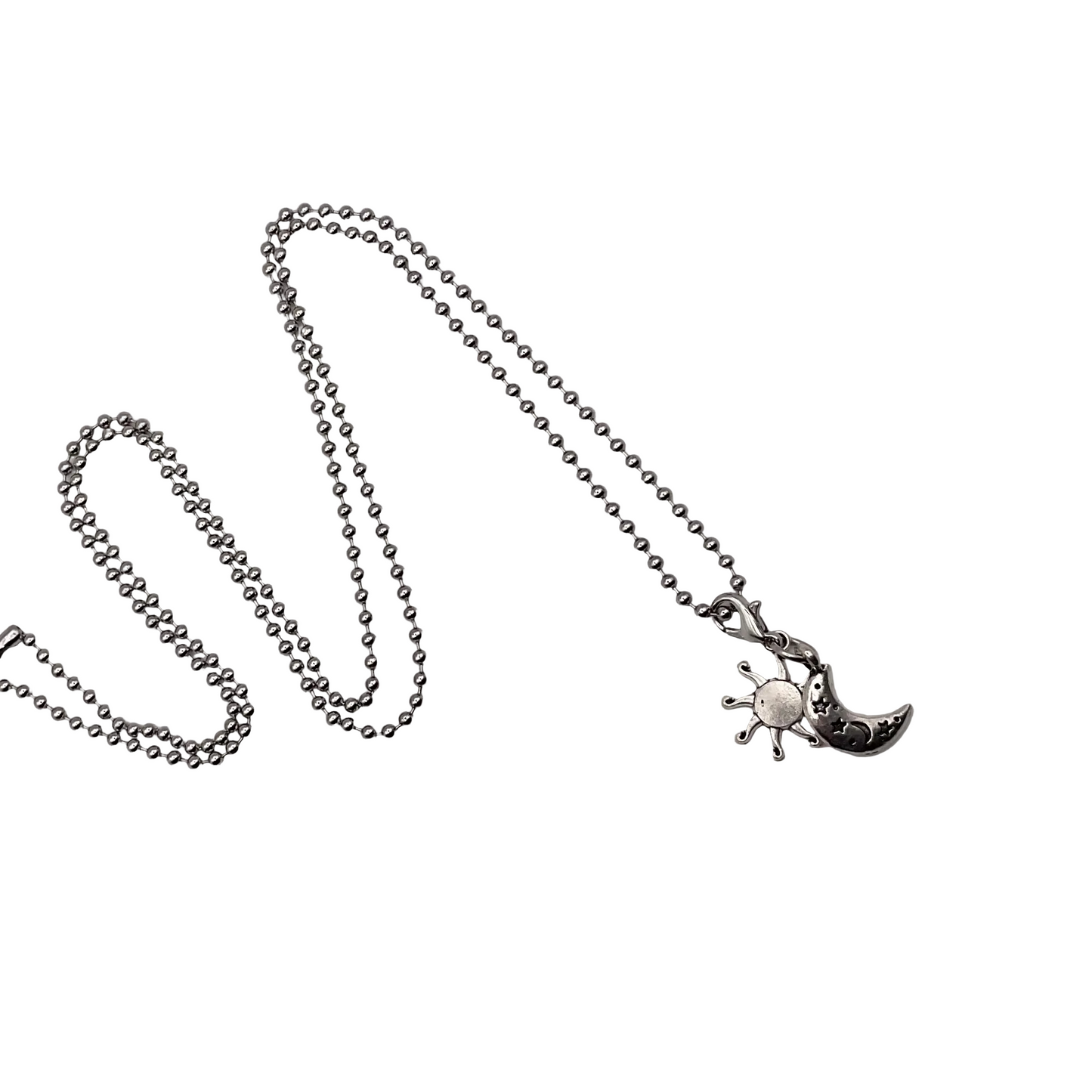Charm Necklace with a sun and moon pendant on a white background.