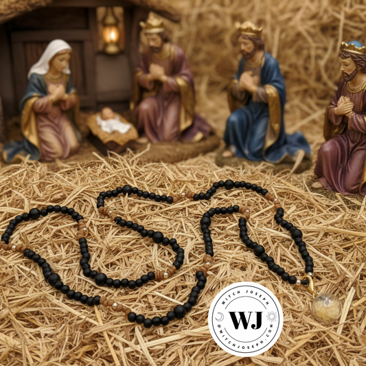 the three kinds amulet shown on a bed of hay with a nativity scene and the Witch Joseph logo