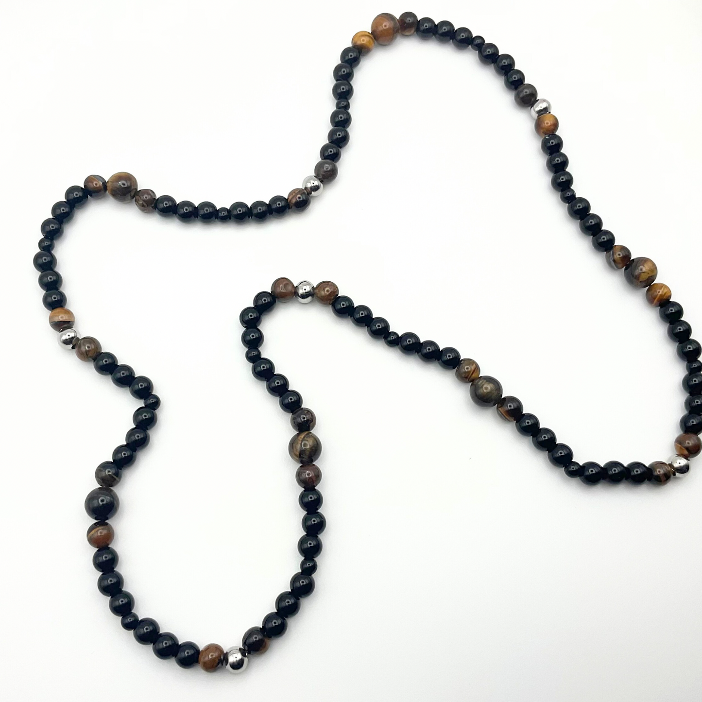 Brown Tigers Eye beaded necklace with black and steel bead accents on a white background.
