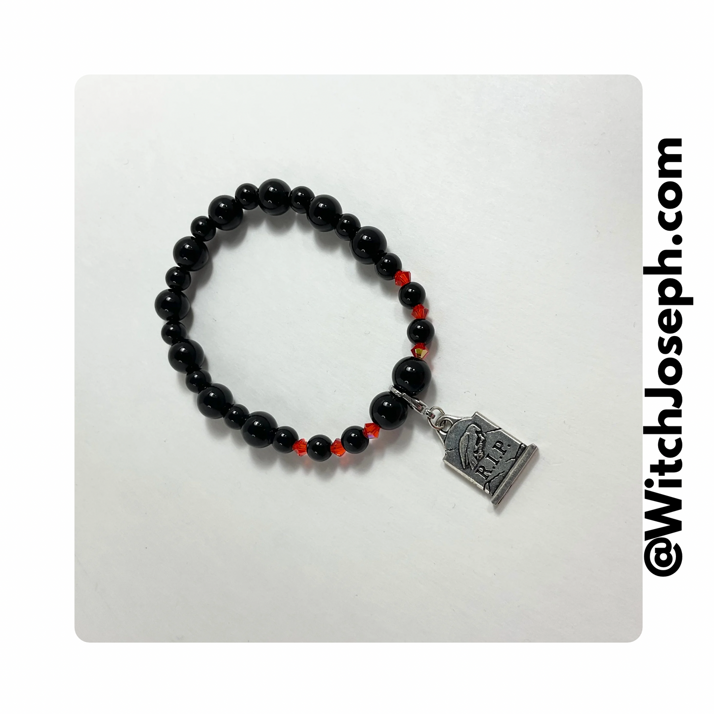 Halloween tombstone charm bracelet with orange and black beads displayed against a light background with the Witch Joseph url.