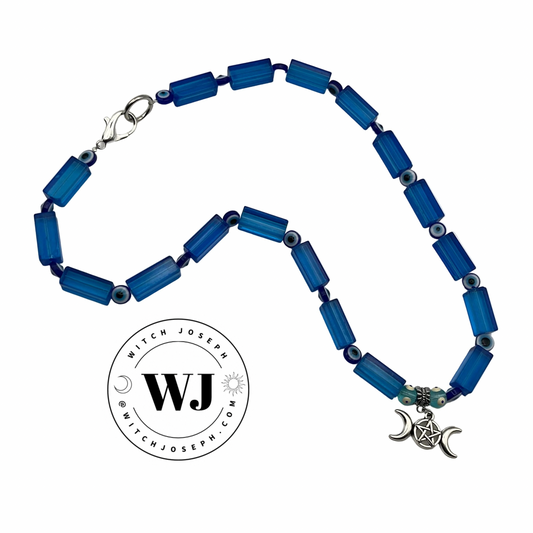 Blue beaded necklace with a silver pendant on a white background, featuring the brand 'Witch Joseph'.