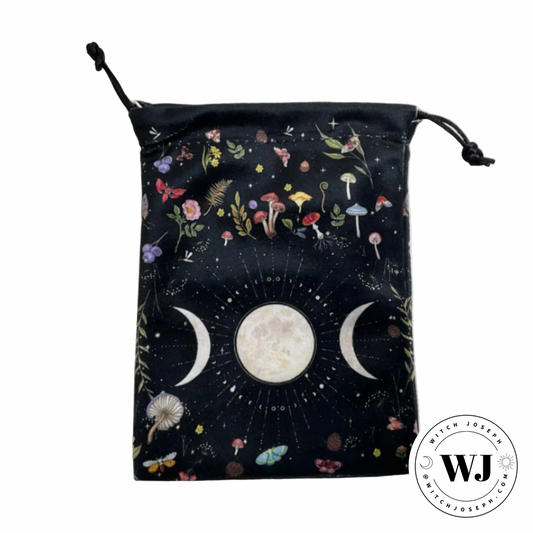 Drawstring bag with celestial triple moon goddess symbols and nature-themed design on a white background