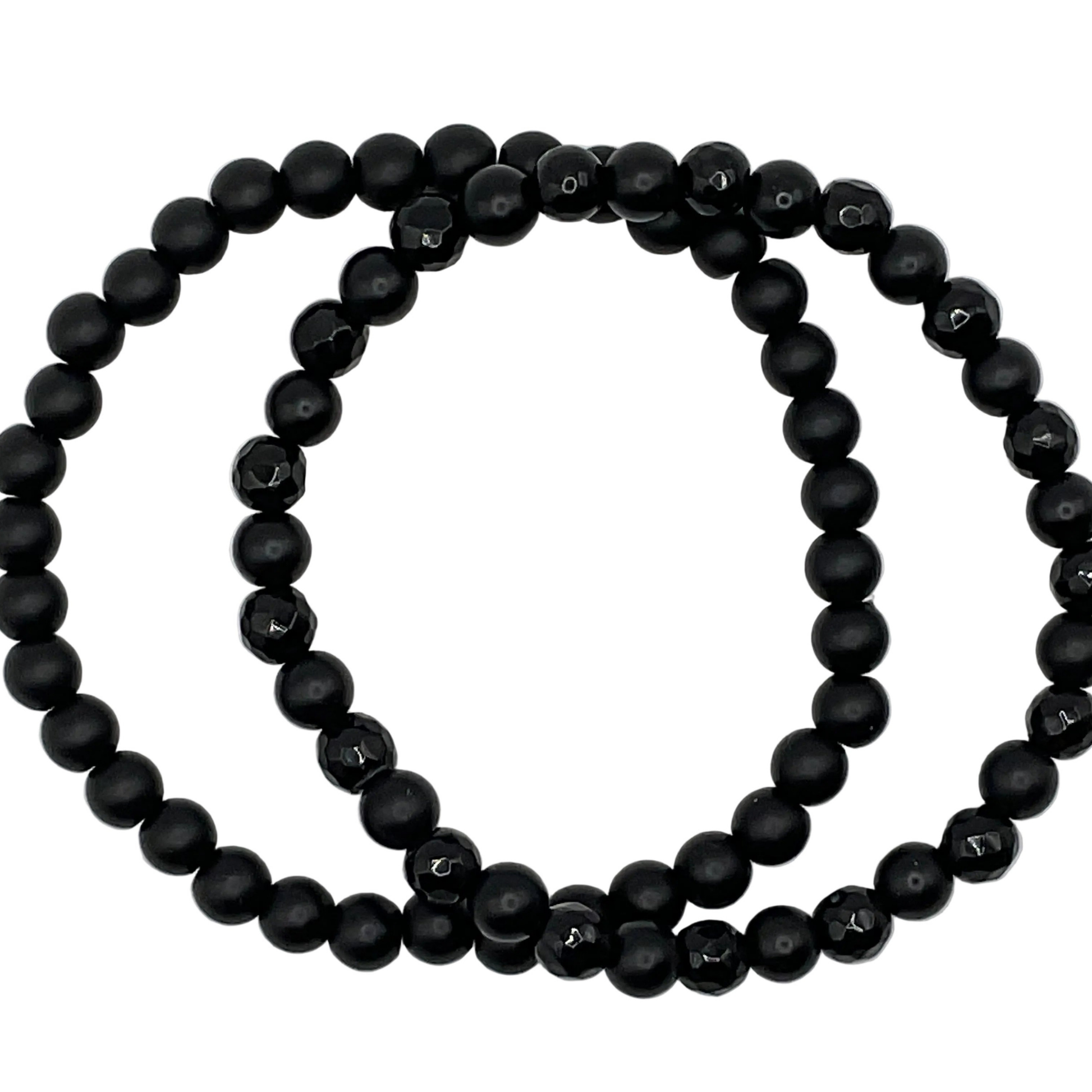 Two black beaded bracelets on a white background