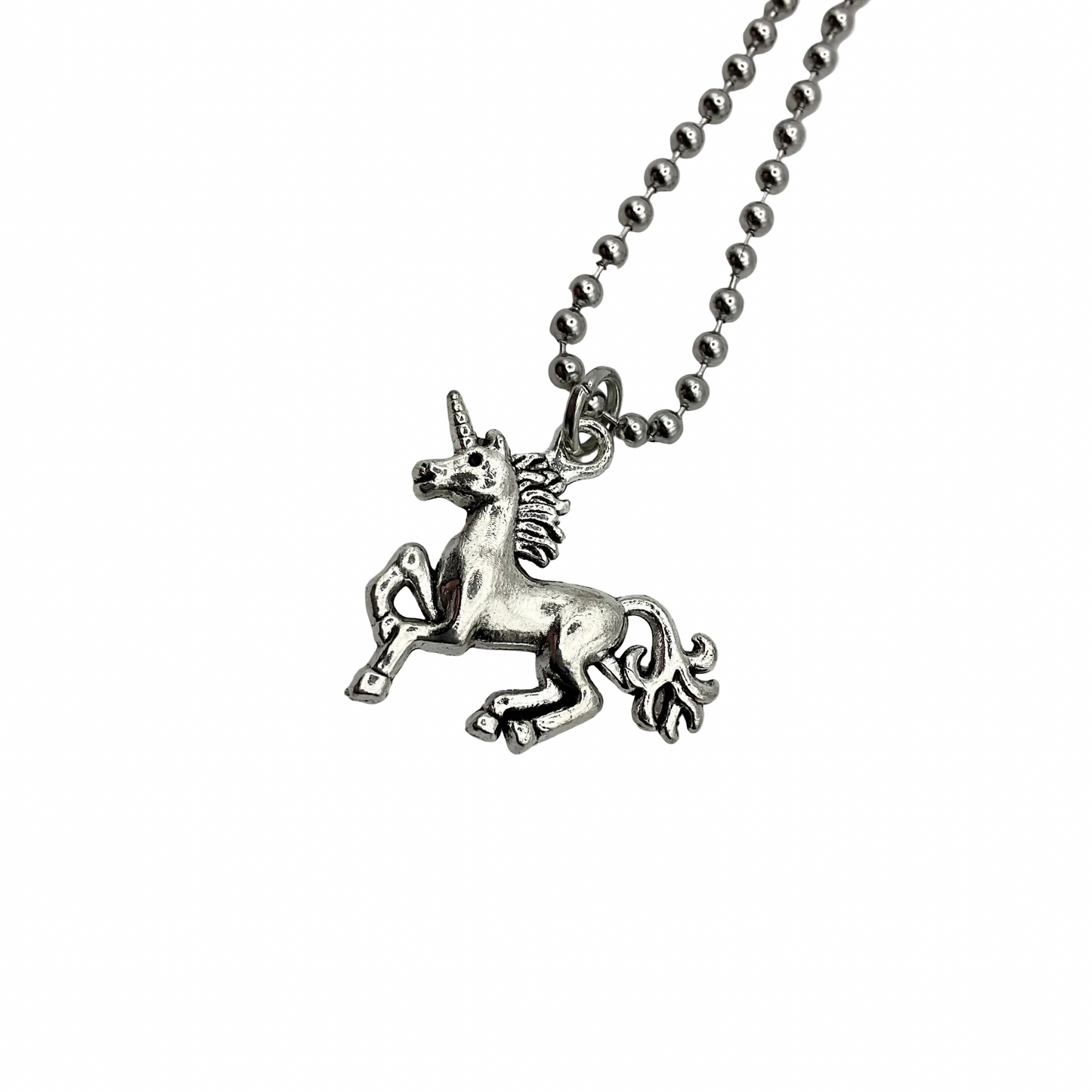 Silver tone unicorn pendant on a ball chain against a white background
