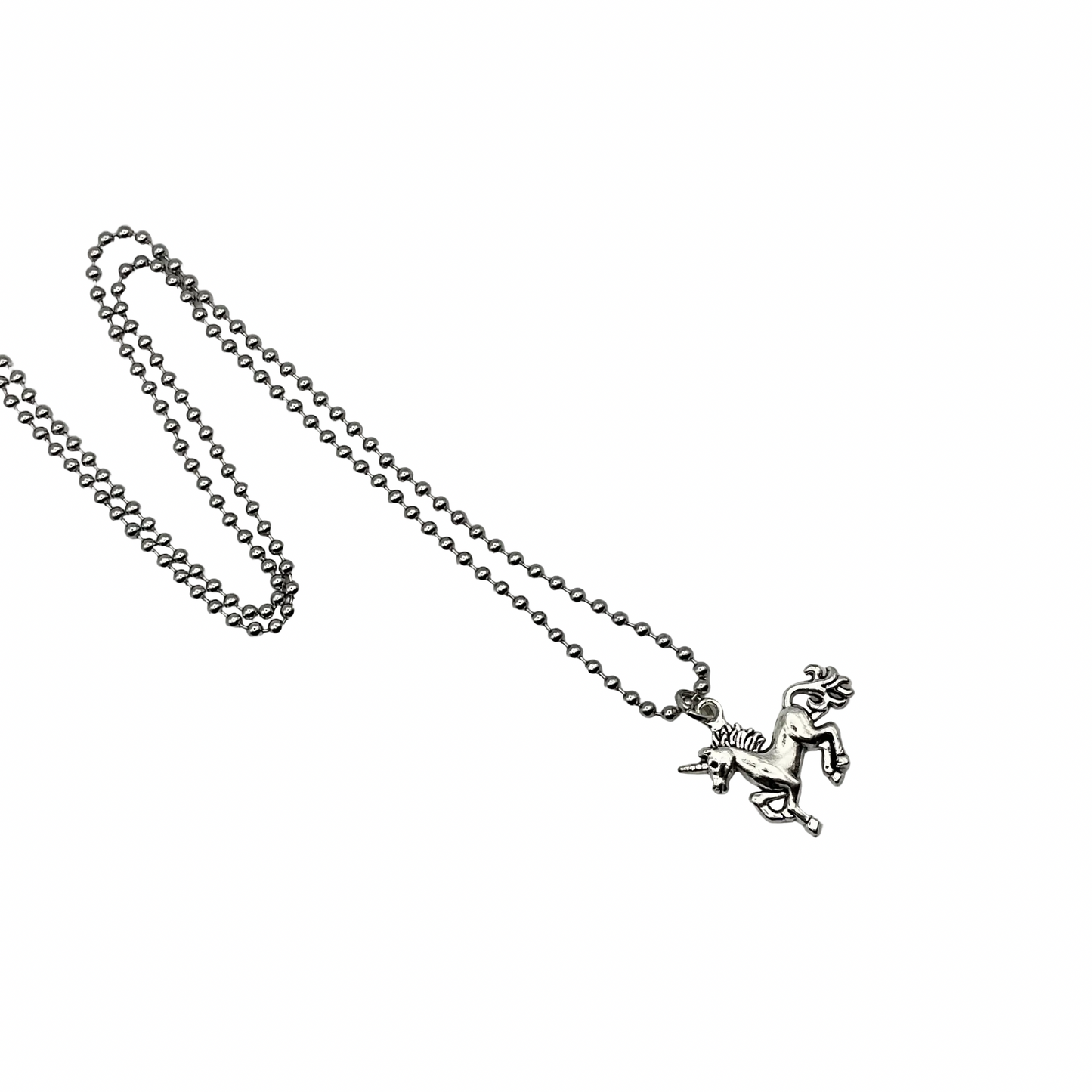 Silver tone necklace with a Unicorn pendant on a white background