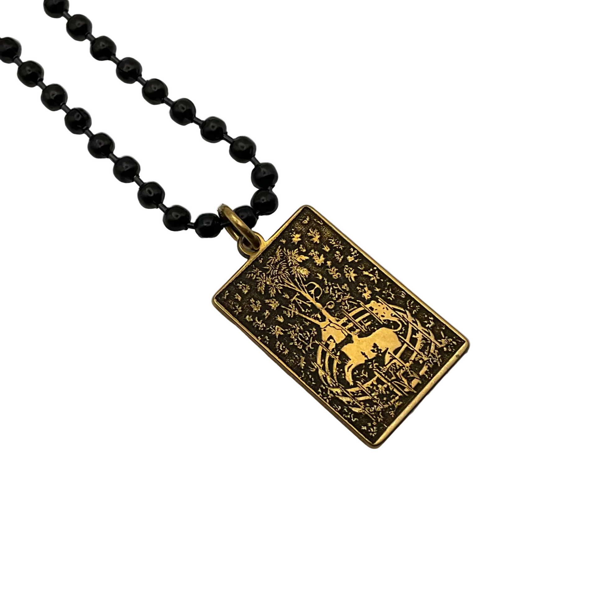 Brass Unicorn  pendant on a black ball chain against a white background