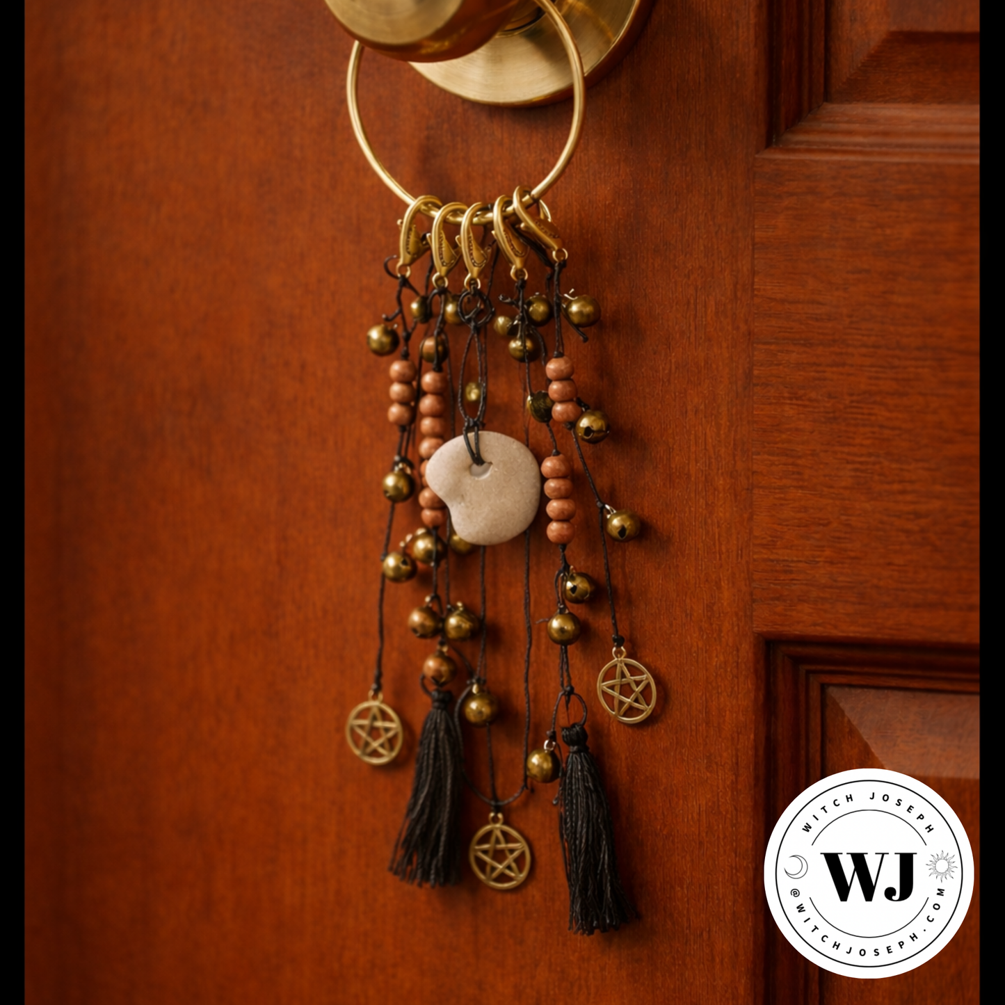 Decorative Door charm or wall hanging with beads, bells, tassels and with a Holey stone on a wooden door, featuring the Witch Joseph logo