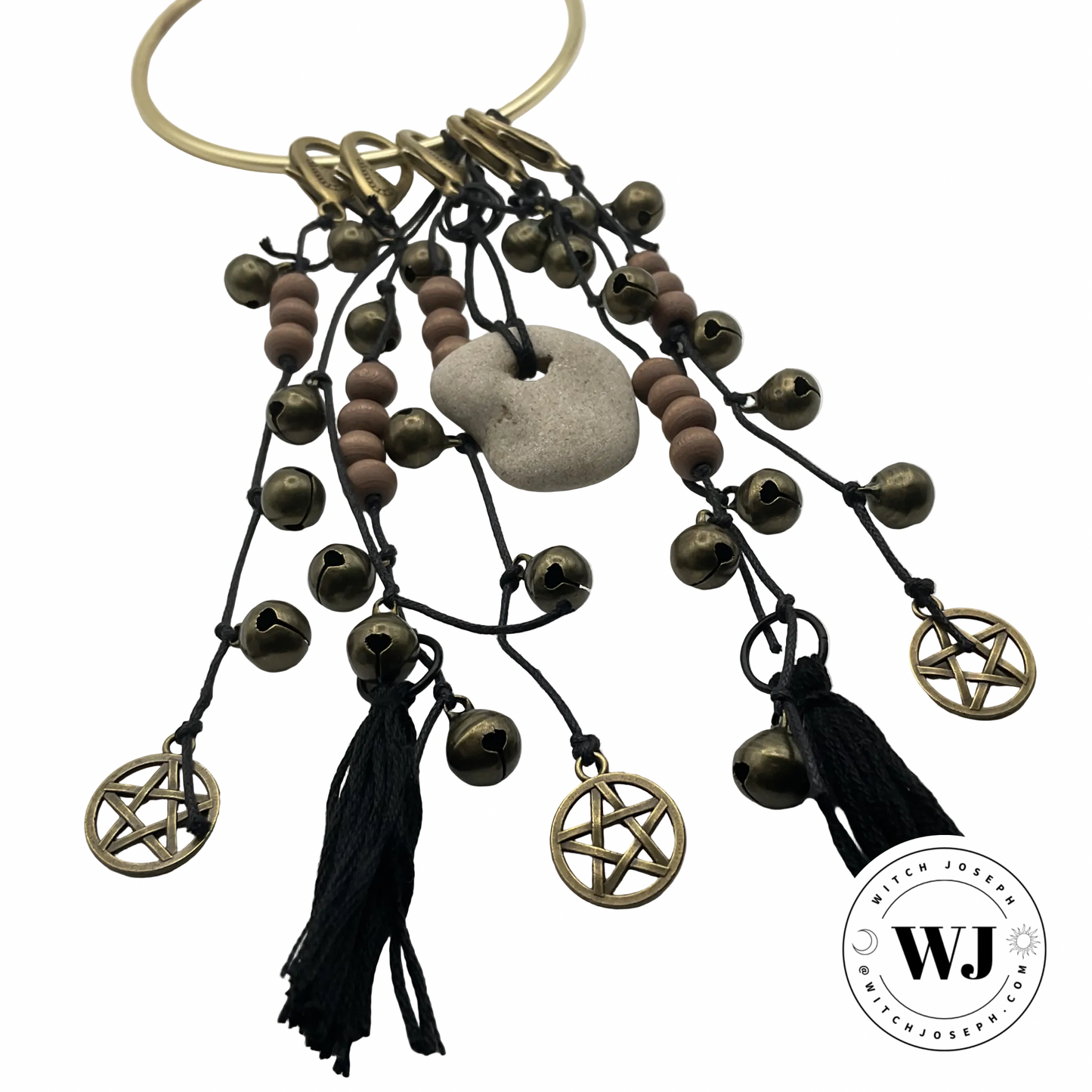 Door hanging Witch ward with pentacle charms, beads, and tassels…and a holy stone displayed on a white background with Witch Joseph logo.