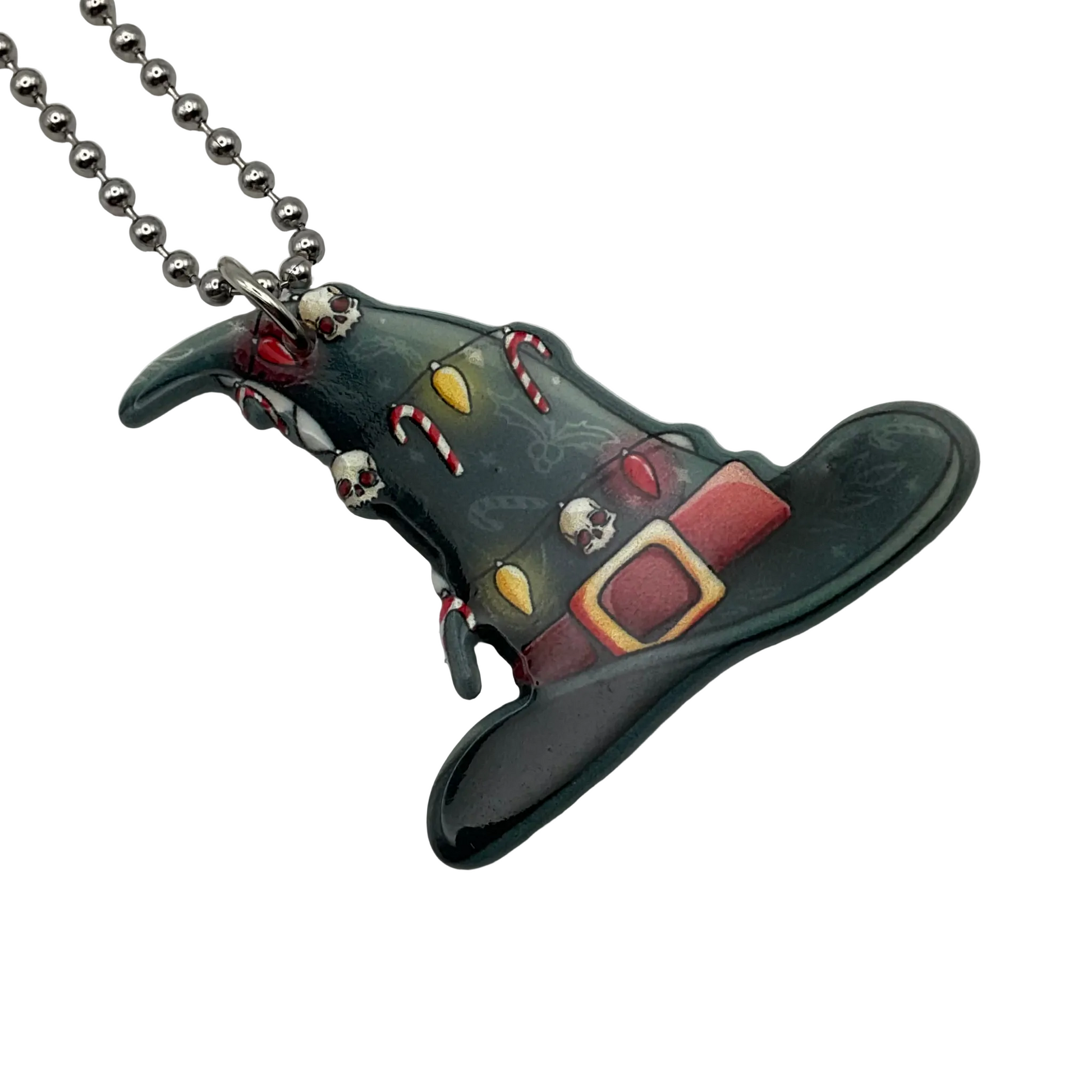 Decorative witch's hat pendant with gothic xmas elements on a ball chain against a white background