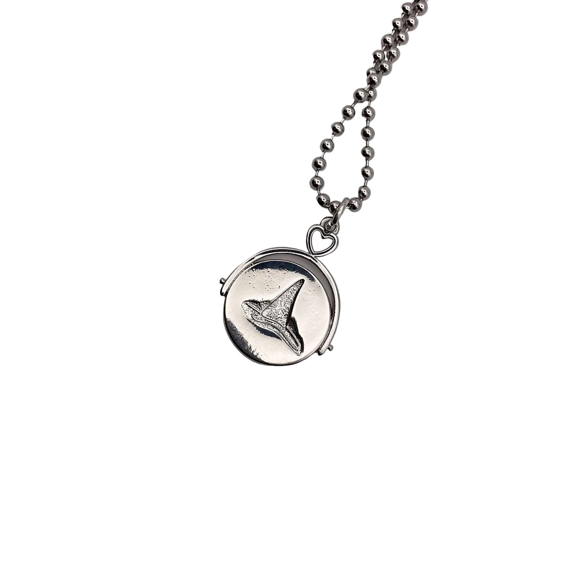 Silver tone necklace with a witch hat pendant on a white background.