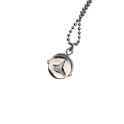 Silver tone necklace with a witch hat pendant on a white background.