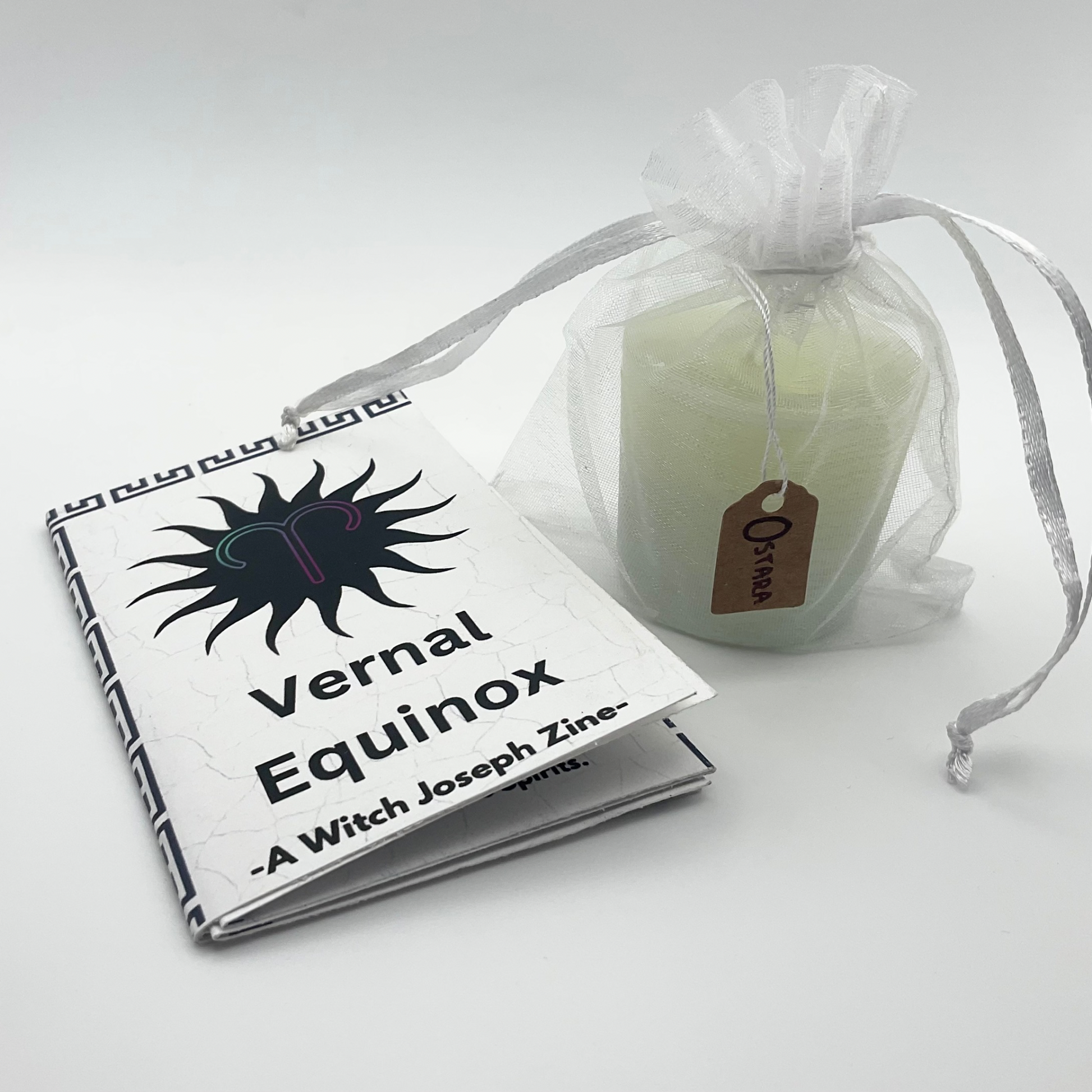 Zine titled 'Vernal Equinox' by Joseph Zine and a candle in a sheer bag on a white background