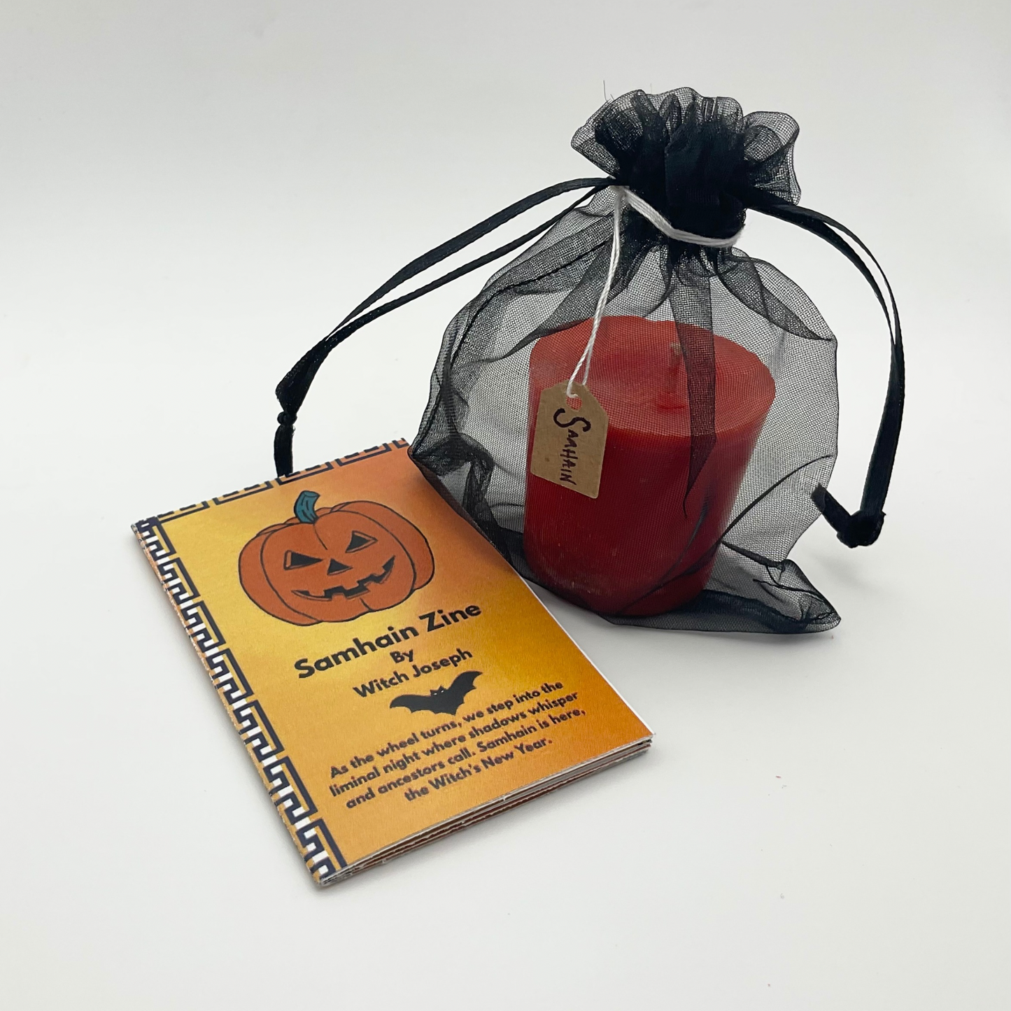The Samhain Candle Lighting Kit…showing the Samhain Candle in a black organza bag and the Witch Joseph Samhain zine against a white background.