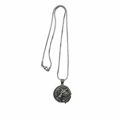 Silver tone necklace with a Wolf pendant on a white background