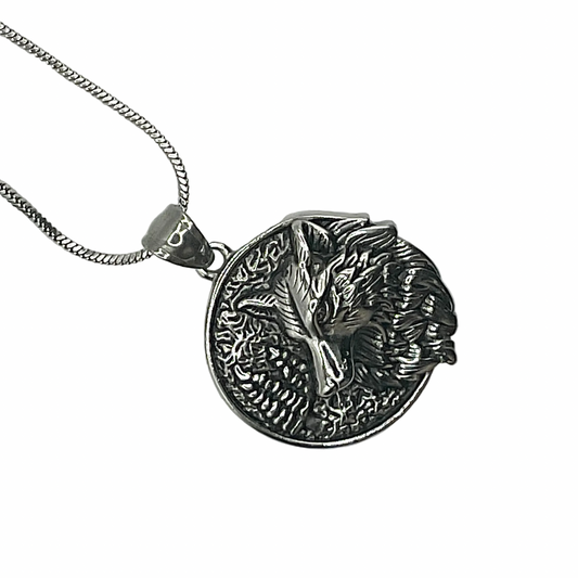 Silver tone steel necklace with a detailed pendant featuring a wolf on a white background