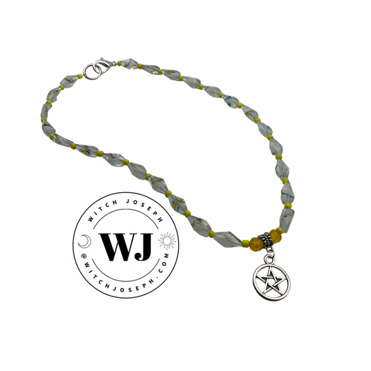 Necklace with yellow art beads and a pentacle charm on a white background, featuring the brand 'Witch Joseph'.