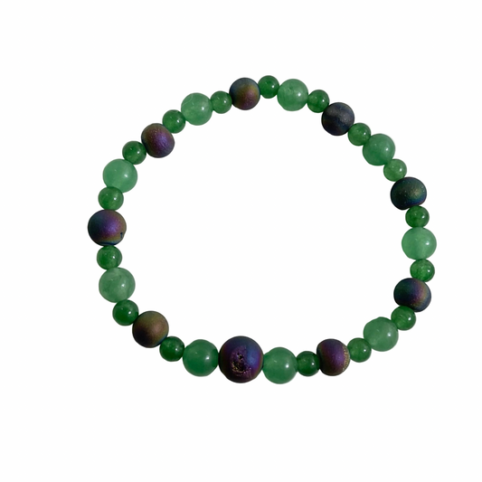 Green aventurine beaded stretch bracelet with purple tone druzy accents displayed on a white background